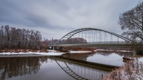Bridge over a river in winter with a reflection in 4K Stock Footage 100686529