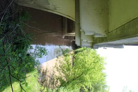 Bridge over Riverbed with twigs located closeup Stock Photos