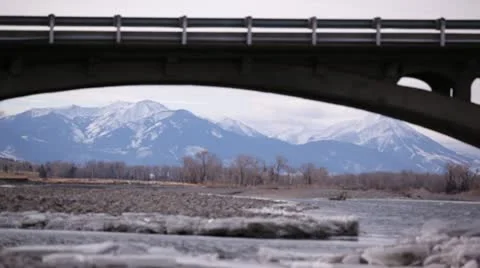 Bridge Over Rocky Stream With Mountaneous Backdrop Stock-Footage 21258193