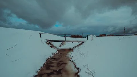 A bridge over a snowy stream Foto stock