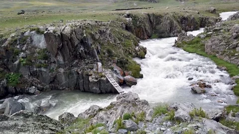 Bridge over a stormy mountain river Stock Footage 147553523