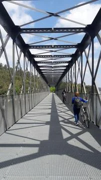 Bridge over trail with cyclists Stock Photos