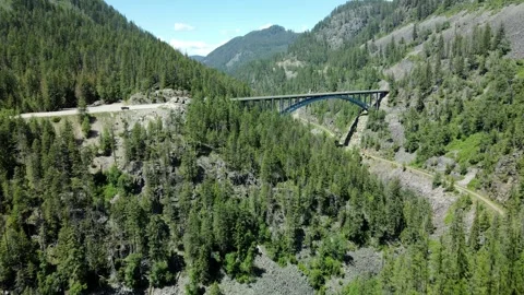 A bridge over a Valley connecting the opposing Mountain side, Aerial View Stock Footage 289486153