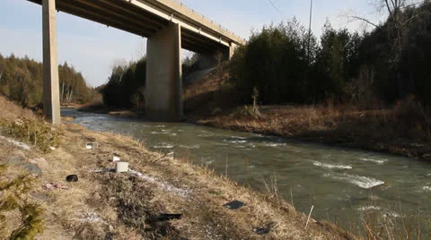 Bridge over valley, creek surrounded by litter. HD 1080p 24fps. Stock Footage 22774837