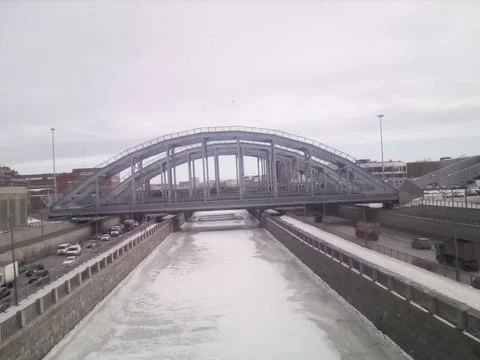 Bridge over the winter river Stock Photos