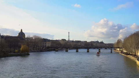 A Bridge in Paris Overlooking the Seine River with Eiffel Tower Stock Footage 128324356