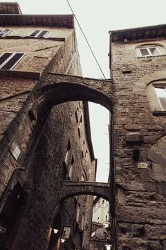 Bridge passages between two medieval stone buildings Stock Photos
