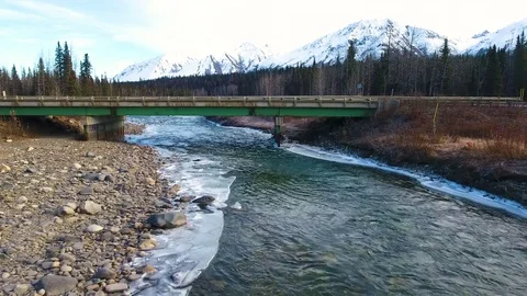 Bridge passing over the flowing river with melting ice Stock-Footage 79641588
