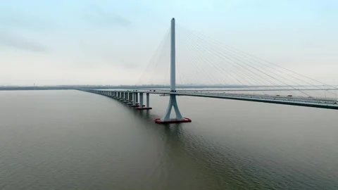 Bridge piers and cable tower above textured river water in Shanghai Stock Footage 346587514