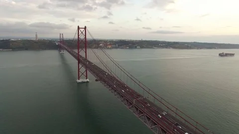 Bridge Ponte 25 de Abril over the Tagus river in Lisbon, Portugal at evening Stock Footage 80277211