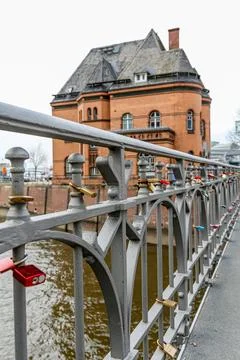 A bridge with a railing that has many locks on it in Hamburg Germany Stock Photos