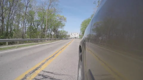 Bridge Reflected in Side of Vehicle as it drives Video stock 50062355