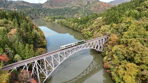 Bridge Reflection | Tadami River Railway | Autumn - 4K Aerial Video Stock Footage 329053287