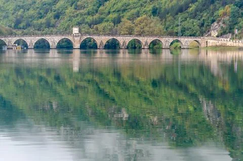 Bridge on the river Drina with reflection of mountains in the water Stock Photos
