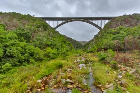 Bridge with the river flowing below Stock Photos