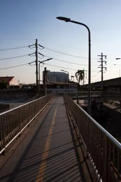 Bridge road with power lines, antennas and building rooftops Stock Photos