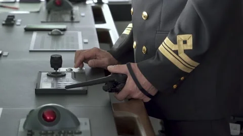 Bridge ship inside. Officer controls vessel. Mate with portable radio in hand Stock Footage 218599487