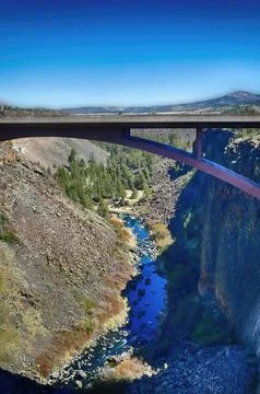 Bridge spanning river gorge on a clear day Stock Photos