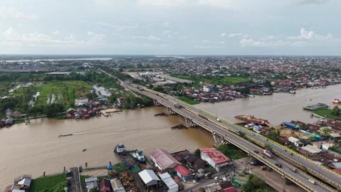 Bridge spanning a wide river is bustling with vehicular activity Stock Footage 336903184