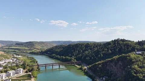 A bridge spans a winding river between wooded and cultivated hills 動画素材 342336066