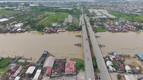 The bridge that stretches across the wide river is filled with vehicle acti.. Stock Footage 334274518