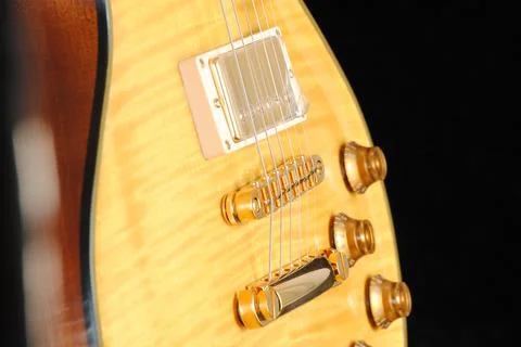 Bridge, strings and pickup of electric guitar on black background Stock Photos