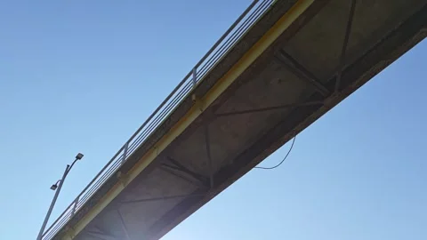 Bridge structure against clear blue sky with sun appearing Stock-Footage 312122610