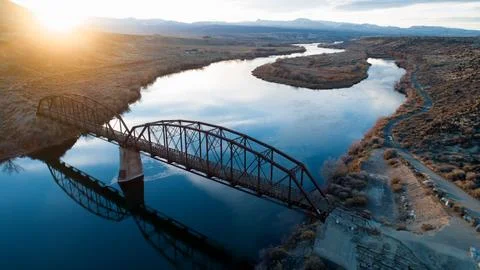 Bridge at sunset going over a river Foto stock