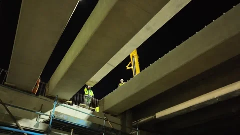 Bridge support beam lifted into place with two cranes at night. Stock Footage 342218356