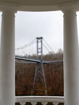 Bridge support in frame of white columns of belvedere Stock Photos