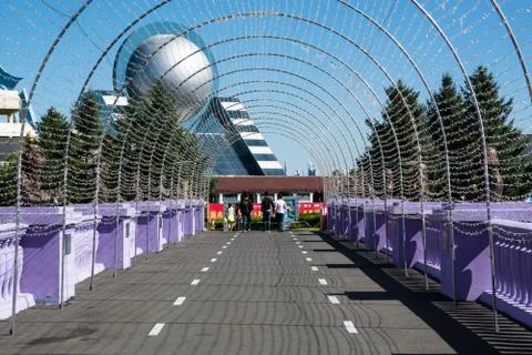 Bridge in the theme park under arch which build from garlands. Stock Photos