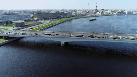 Bridge through big river with blue water and barge pullin up in the big city Stock Footage 91045093