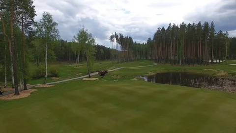 Bridge through pond on golf field Stock Footage 76940280