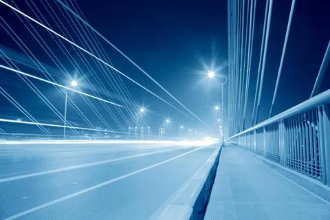 Bridge traffic at night cable stayed bridge in traffic at night,blue tone ... Stock Photos