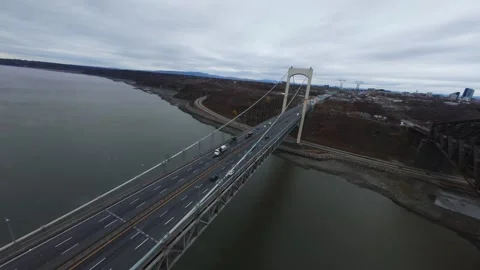 Bridge traffic over autumn foliage and river Stock Footage 320588271