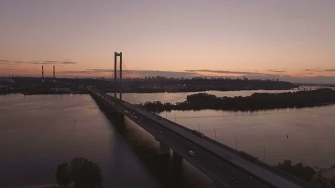 Bridge with trafic over the river at sunset aerial drone footage Stock Footage 84982510