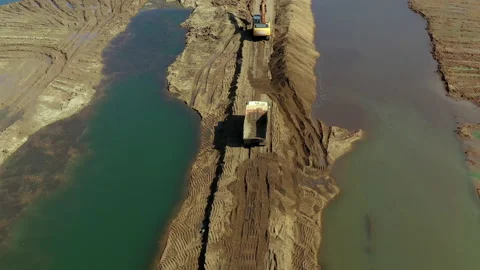 Bridge under construction over a river. Equipment on the bridge under Stock Footage 143764316