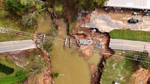 Bridge washed out completely by the flood waters of Hurricane Helene. Drone Stock Footage 296747903