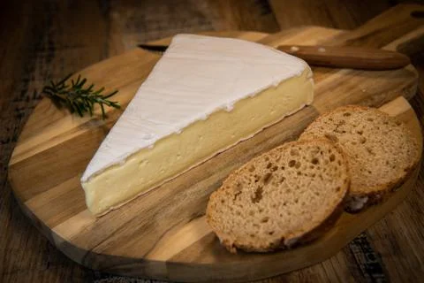 Brie cheese triangle with bread and parsley Stock Photos