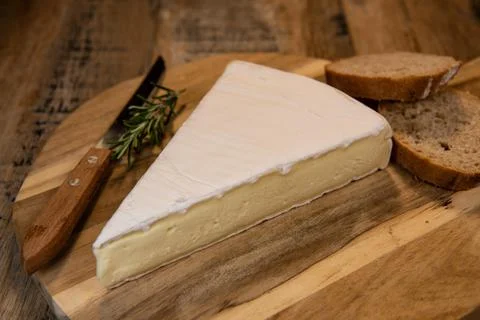 Brie cheese triangle with bread and parsley Stock Photos
