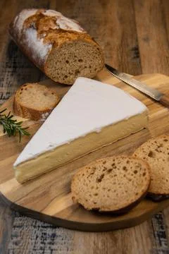 Brie cheese triangle with bread and parsley Stock Photos