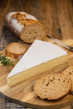 Brie cheese triangle with bread and parsley Stock-Fotos