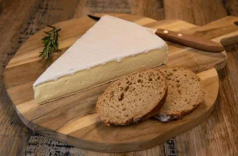 Brie cheese triangle with bread and parsley Stock Photos