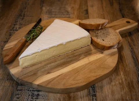 Brie cheese triangle with bread and parsley Stock Photos