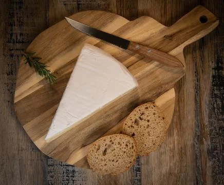 Brie cheese triangle with bread and parsley Stock Photos