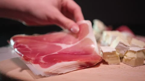 Brie prosciutto cheese Cured raw ham, spinning. Slices of prosciutto crudo Video stock 303503998