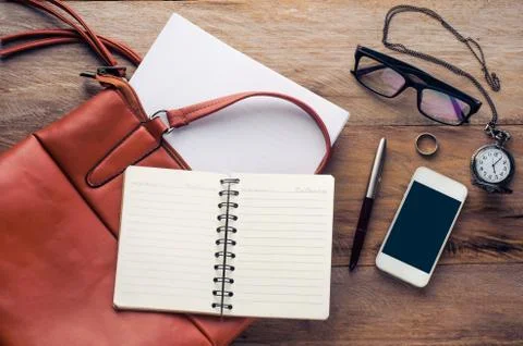 Briefcase and document on wooden floor Stock Photos