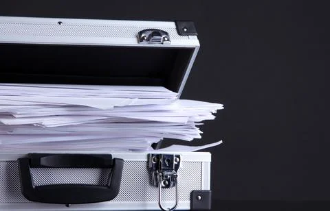 Briefcase full of papers, isolated on black Stock Photos