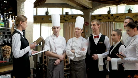 Briefing at the restaurant. Interacting to head manager in commercial hall Video stock 125814932