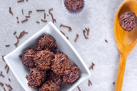 "Brigadeiro" candy in a white form next to others in a white bowl and woode.. Stock Photos